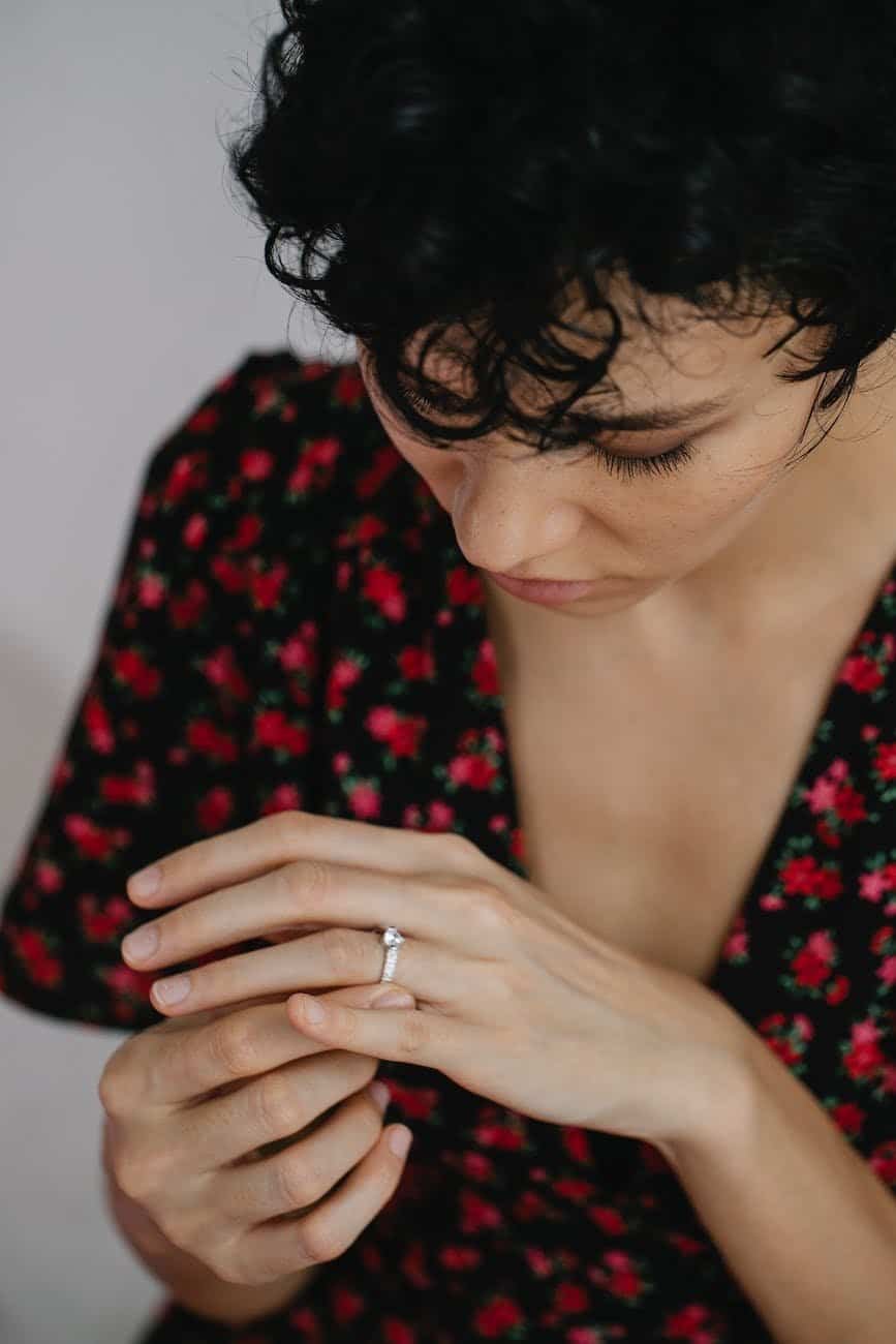 a woman looking at her engagement ring
