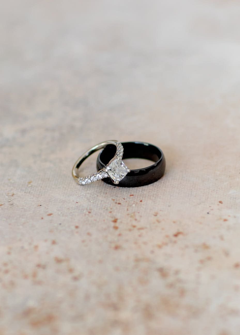 silver diamond ring on black ring