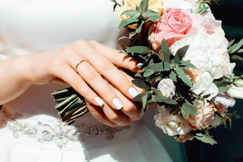 Simple engagement rings Woman Holding White and Pink Roses